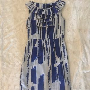 Mid-length professional dress with ruffle.